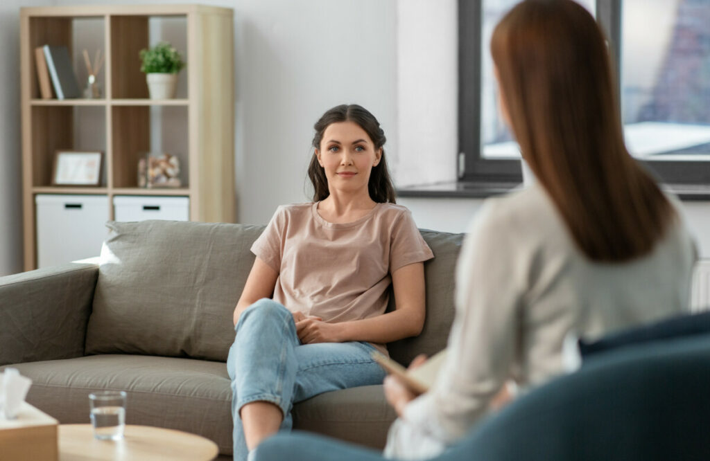 woman and psychologist at psychotherapy session, mental health,