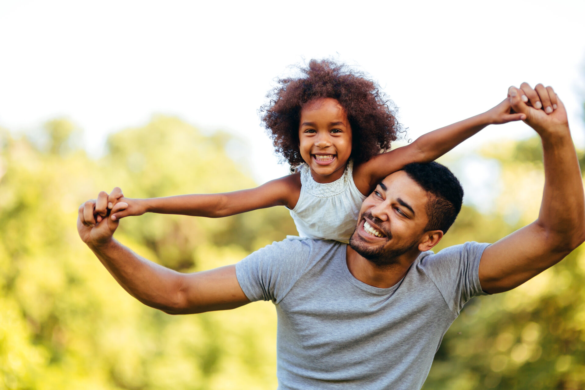 Portrait,Of,Young,Father,Carrying,His,Daughter,On,His,Back